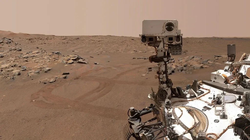 Perseverance Mars rover took a selfie over a rock with two holes where the rover used its robotic arm to drill rock core samples.