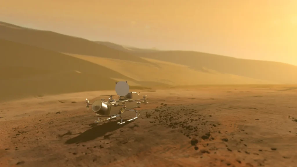 Dragonfly rotorcratf facing away on the rust-orange surface with giant dunes in the background and a hazy yellow sky