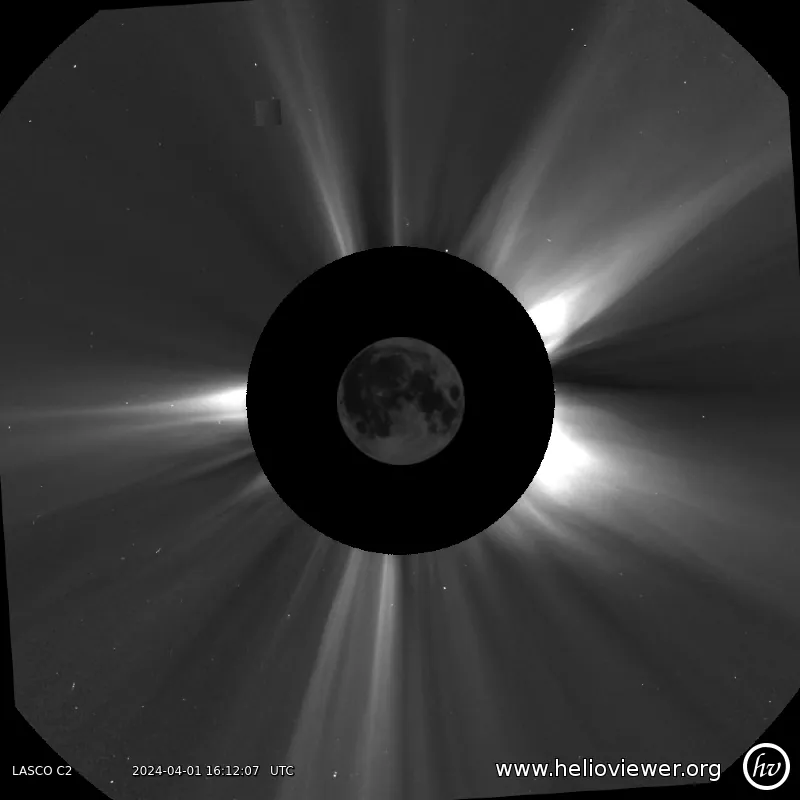 A gray image showing the Moon in the center, a black circle around it, and white streams of light flowing out.