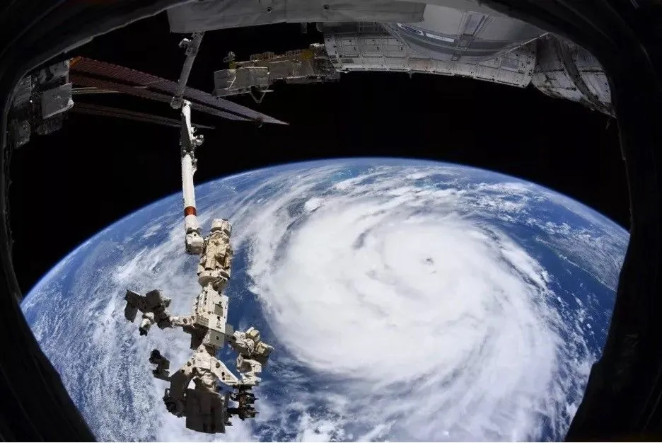 An image of Earth from space showing a hurricane forming over the ocean.