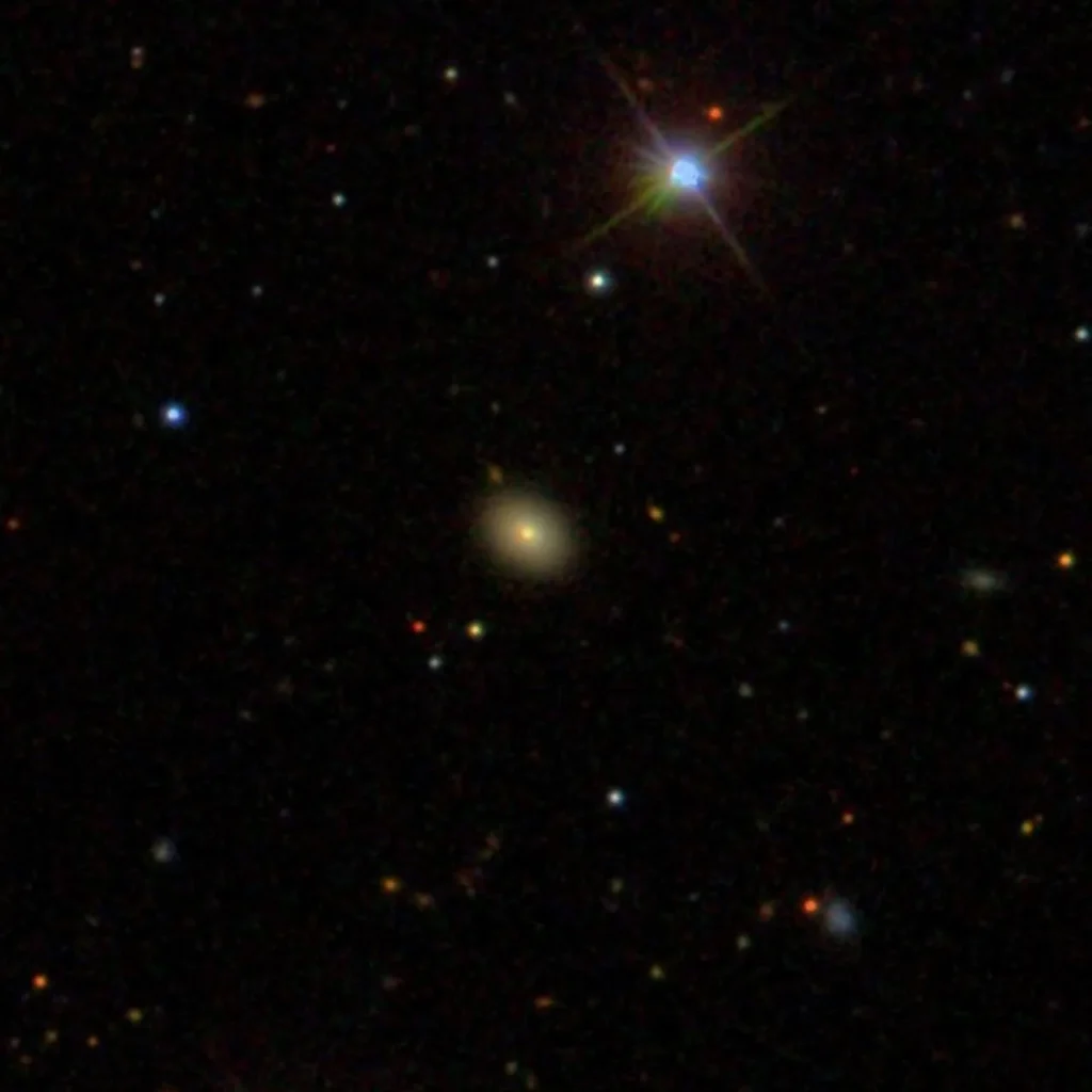 A red circle encompasses a galaxy in a snapshot of an all-sky survey.