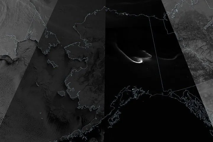 A grayscale composite satellite image centered on Alaska shows observations at several times during a total lunar eclipse. Snow, ice, and clouds appear bright in swaths acquired before and after the eclipse and darker gray in the partial phase. The scene during the total phase is mostly black.