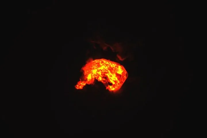 The heat signature from an eruption at Kilauea glows yellow and orange in the volcano’s summit crater.