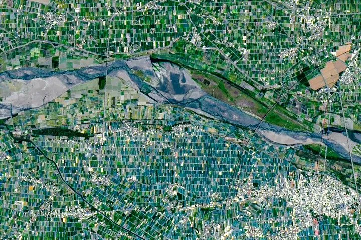 Farm fields around Xiluo appear a darker shade of green than other parts of the image because of shade nets.