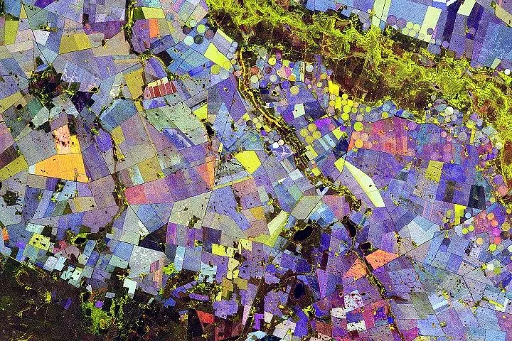 A visualization of agricultural land in South Africa shows geometric fields in an array of colors that combine red, green, and blue.