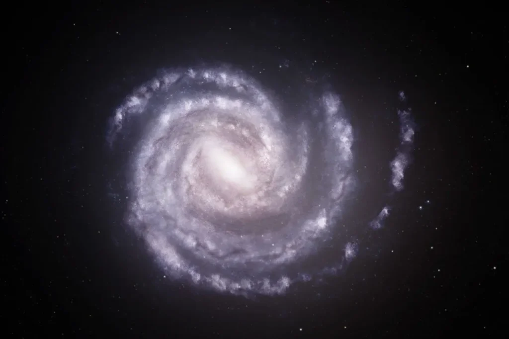 An artist’s concept showing the Milky Way galaxy as seen from above, with the estimated positions of spiral arms based on previous data, in blue. Overlaid on this is an updated view of the Milky Way showing different positions for the two outermost spiral arms, shown in red and bordered by dashed lines. Both arms may be more distant than previously thought, based on newly-processed X-ray data from Chandra and XMM.